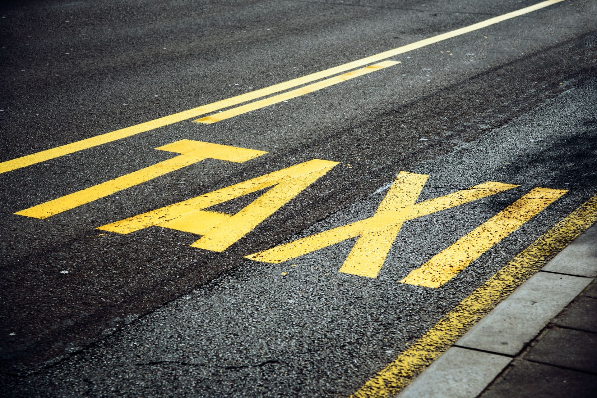 TAXI sign on the asphalt